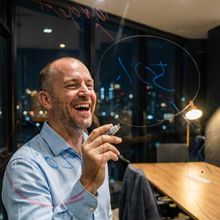 A founder laughing in a bar