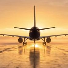 An aircraft on the runway at sunset